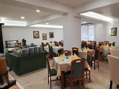 a restaurant with tables and chairs in a room at Hotel Prebold in Prebold