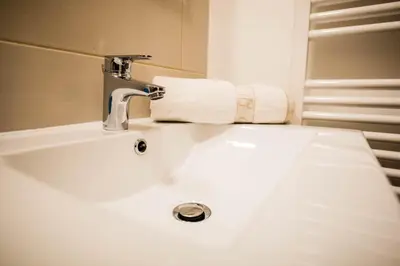 a bathroom sink with a faucet and a towel at Apartma Marjetica 2 in Moravske Toplice
