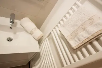 a bathroom with a white radiator and a sink at Apartma Marjetica 2 in Moravske Toplice