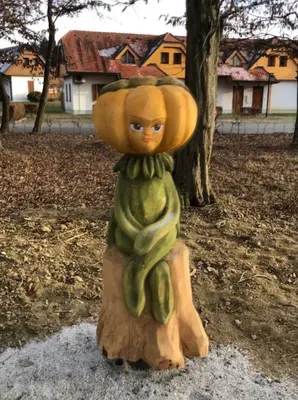a statue of a person dressed in a tree stump at Apartma Marjetica 2 in Moravske Toplice