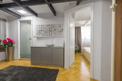 a room with white walls and a doorway with a mirror at Tržaška Duplex Urban Apartment in Ljubljana