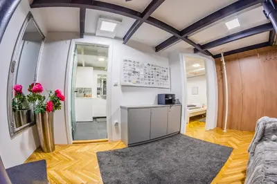 a room with a vase of flowers on a table at Tržaška Duplex Urban Apartment in Ljubljana