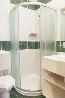 a bathroom with a shower and a toilet and a sink at Julija&Robert's Riverview Apartments and Rooms in Ljubljana