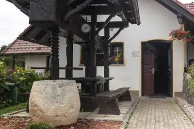 a house with a clock on the front of it at Apartment Velbana Gorca in Virštanj