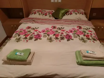 a bed with towels and flowers on it at Cosy apartment in Kranjska Gora