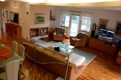 a living room with a couch and chairs and a television at Cosy apartment in Kranjska Gora