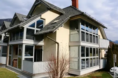a house with a lot of windows at Cosy apartment in Kranjska Gora