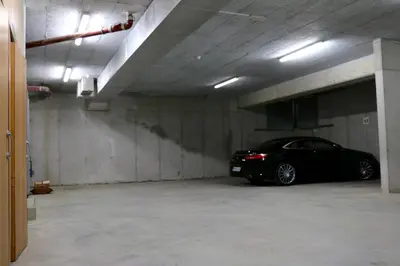 a black car parked in a parking garage at Cosy apartment in Kranjska Gora
