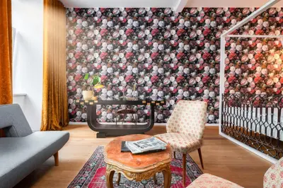 a living room with a fireplace with a wall of balls at Tromostovje apartments in Ljubljana