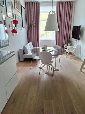 a kitchen and living room with a table and chairs at Tromostovje apartments in Ljubljana