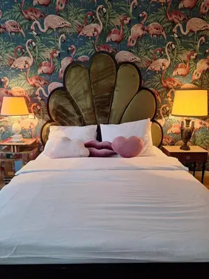 a bed with two stuffed animals sitting on top of it at Tromostovje apartments in Ljubljana