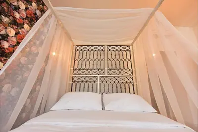 a bed in a room with a window at Tromostovje apartments in Ljubljana
