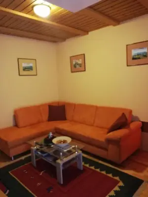 a living room with a couch and a table at Apartment Bolfenk in Pohorje