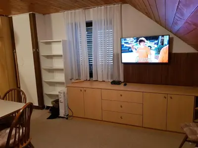 a living room with a tv on a wall at Apartment HM in Gozd Martuljek