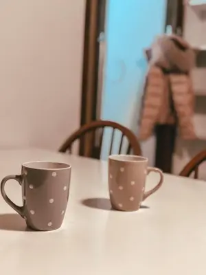 two coffee cups sitting on top of a table at Apartment HM in Gozd Martuljek