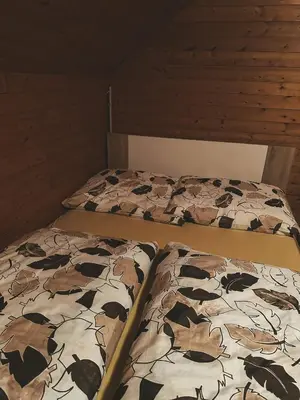 two twin beds in a room with a cow blanket at Apartment HM in Gozd Martuljek