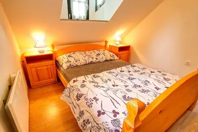 a small bedroom with a bed and two night stands at Apartment Sara in Vitanje