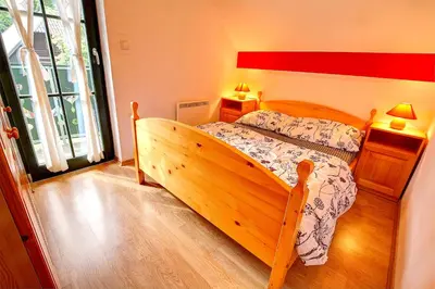 a bedroom with a wooden bed in a room at Apartment Sara in Vitanje
