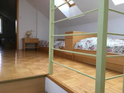 a bedroom with two bunk beds and a wooden floor at J-Max in Bled