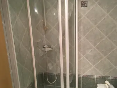 a shower with a glass door in a bathroom at J-Max in Bled
