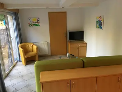 a living room with a green couch and a television at J-Max in Bled