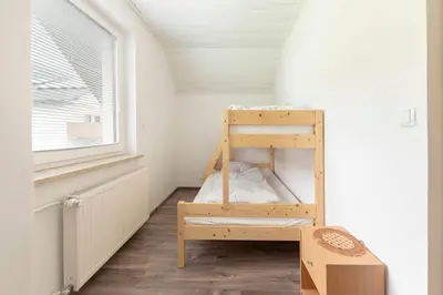 a small room with a bunk bed and a window at Apartmaji Seljak in Preddvor