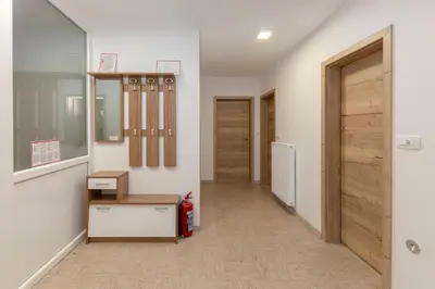 a hallway with a door and a fire extinguisher at Apartmaji Seljak in Preddvor