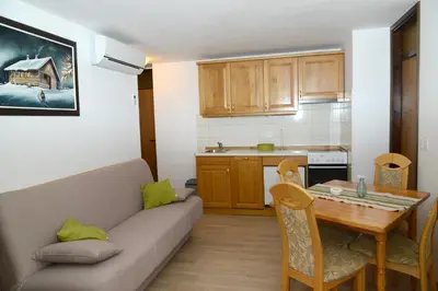 a living room with a couch and a table at Apartmaji Rabič in Bohinj