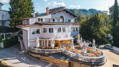 a large white house with a boat in front of it at Central Bled House in Bled