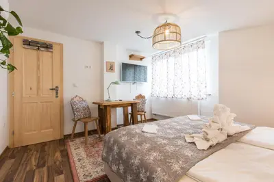 a bedroom with a bed and a table and a window at Central Bled House in Bled