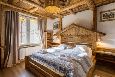 a bedroom with a large bed with towels on it at Central Bled House in Bled