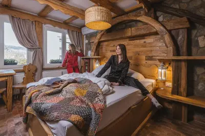 a woman sitting on top of a bed in a room at Central Bled House in Bled
