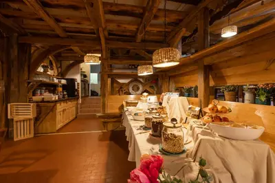 a dining room with a long table in a kitchen at Central Bled House in Bled