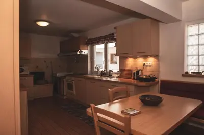 a kitchen with a wooden table and a wooden table and a tableablish at Učni ranč Bohinj, Boutique Horse-Friendly Retreat in Bohinj