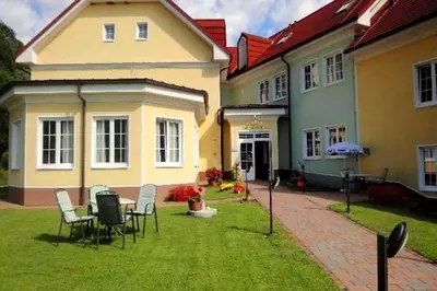 a house with a table and chairs in the yard at Hotel Cateski Dvorec in Čatež ob Savi