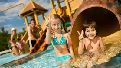 two children in the water on a water slide at Hotel Cateski Dvorec in Čatež ob Savi