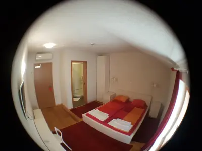 a small bedroom with a bed in a room at Guesthouse Stari Tišler in Ljubljana