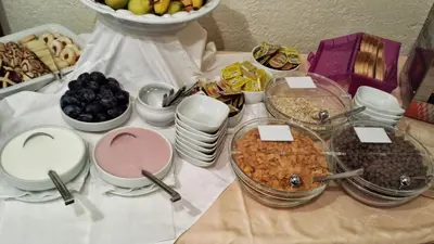 a table topped with plates and bowls of food at Guesthouse Stari Tišler in Ljubljana
