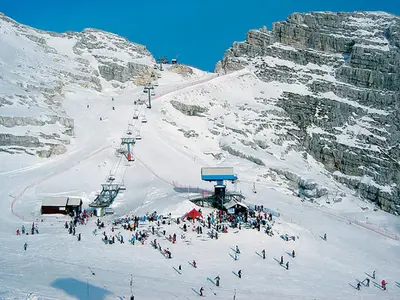 a group of people on a snow covered ski slope at Apartment Mavrica in Bovec