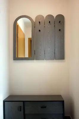 a mirror and a wooden dresser in a room at Apartment Mavrica in Bovec
