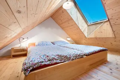 a bedroom with a bed in a attic at Homestead farm Tešnak in Gorenja Vas