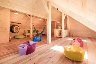 a room with a hammock in a wooden house at Homestead farm Tešnak in Gorenja Vas