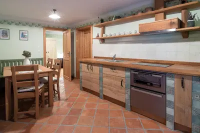 a kitchen with a table and a counter top at Homestead farm Tešnak in Gorenja Vas