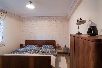 a bedroom with a bed and a lamp and a dresser at Homestead farm Tešnak in Gorenja Vas