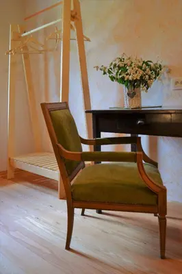 a chair sitting in front of a desk with a piano at Homestead farm Tešnak in Gorenja Vas