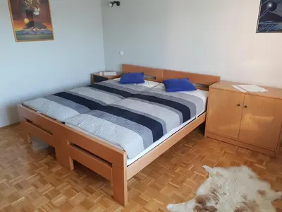 a bedroom with a bed with blue pillows on it at Apartment Milena in Maribor