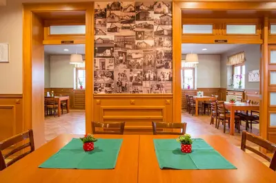 a dining room with a table with green napkins at Guesthouse Beno in Starše