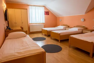 a hospital room with three beds and a window at Guesthouse Beno in Starše