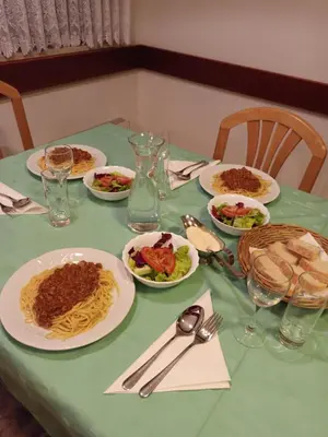 a green table with plates of food on it at Bed&Breakfast Zilje in Vinica