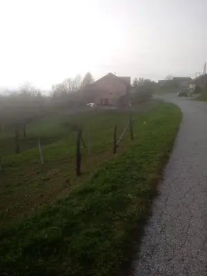 a fence on the side of a road next to a house at Bed&Breakfast Zilje in Vinica